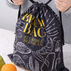 Reusable beeswax bread bag with drawstring closure being tightened for secure food storage