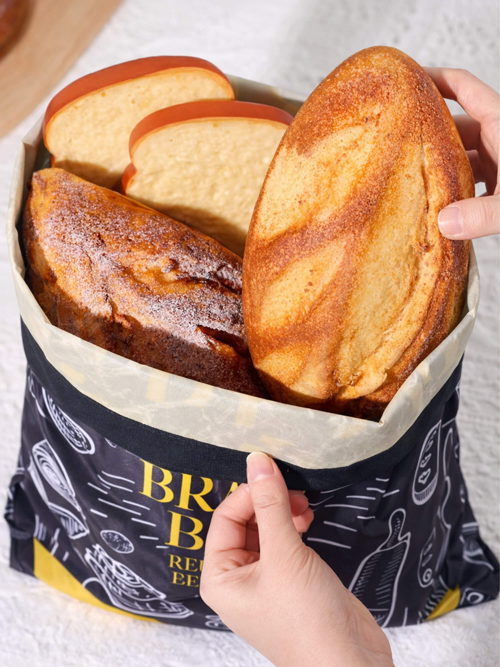 Beeswax lined bread bag storing fresh homemade loaves to keep bread fresher for longer