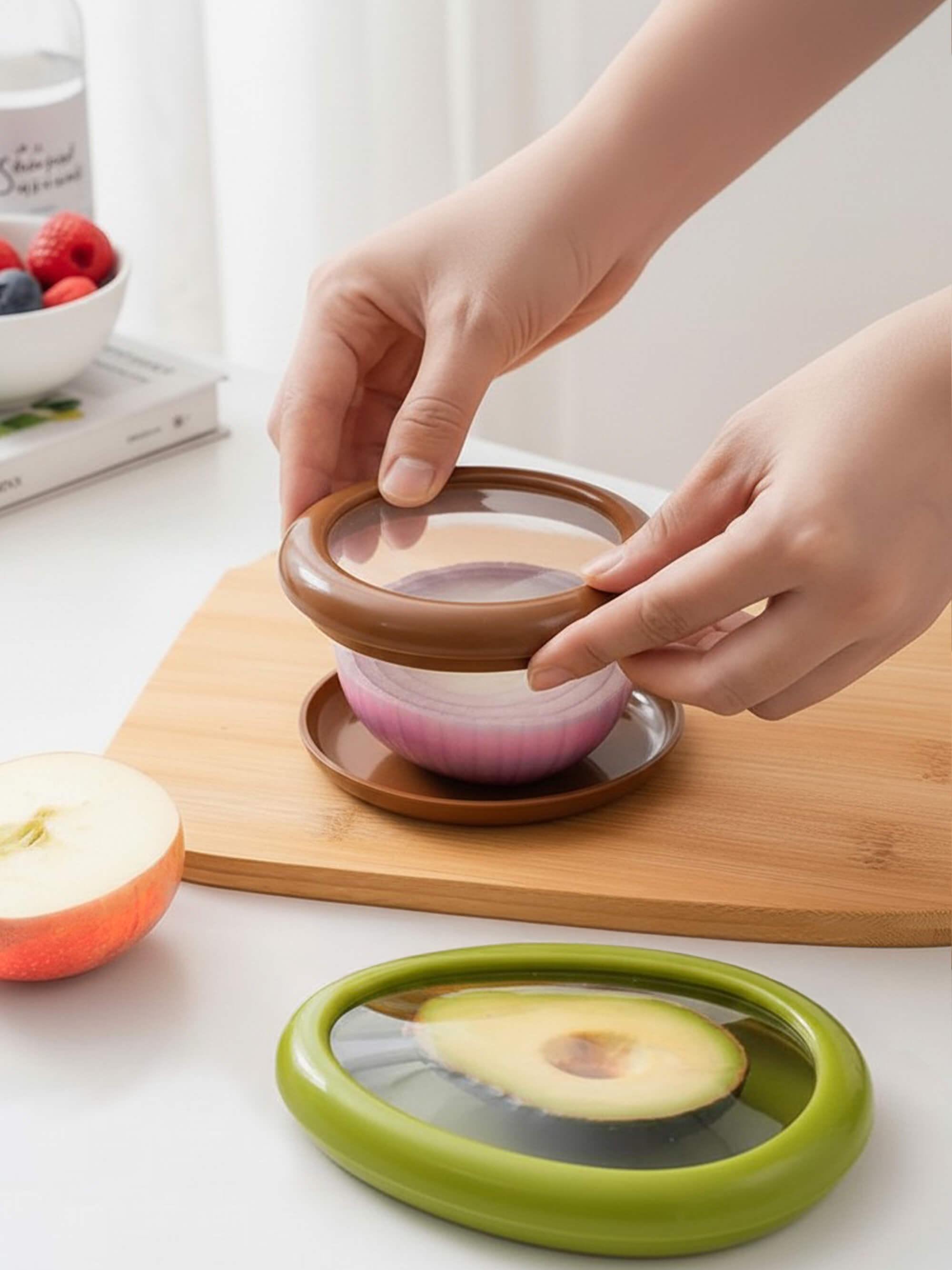 Reusable silicone food saver lid covering half a red onion to keep it fresh in the fridge