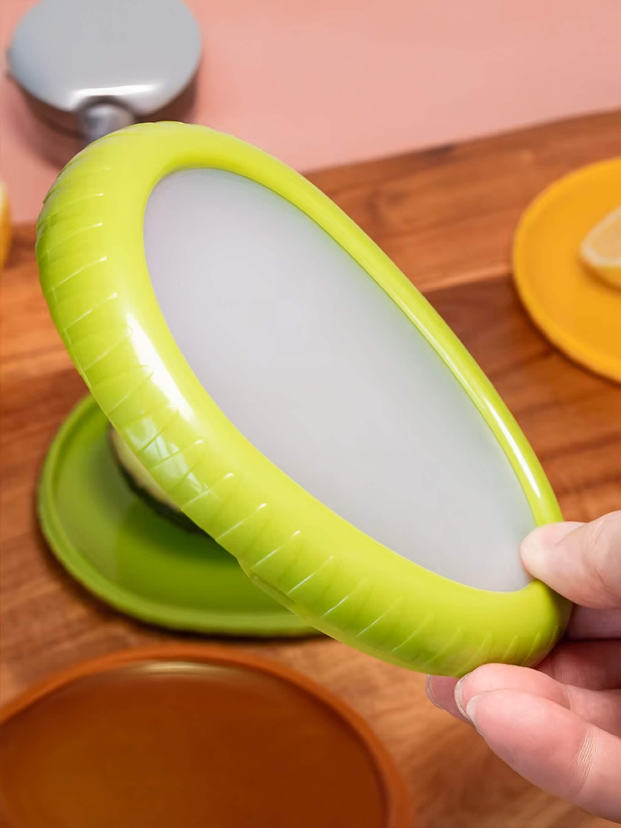 Reusable silicone avocado saver container storing half avocado with flexible lid seal