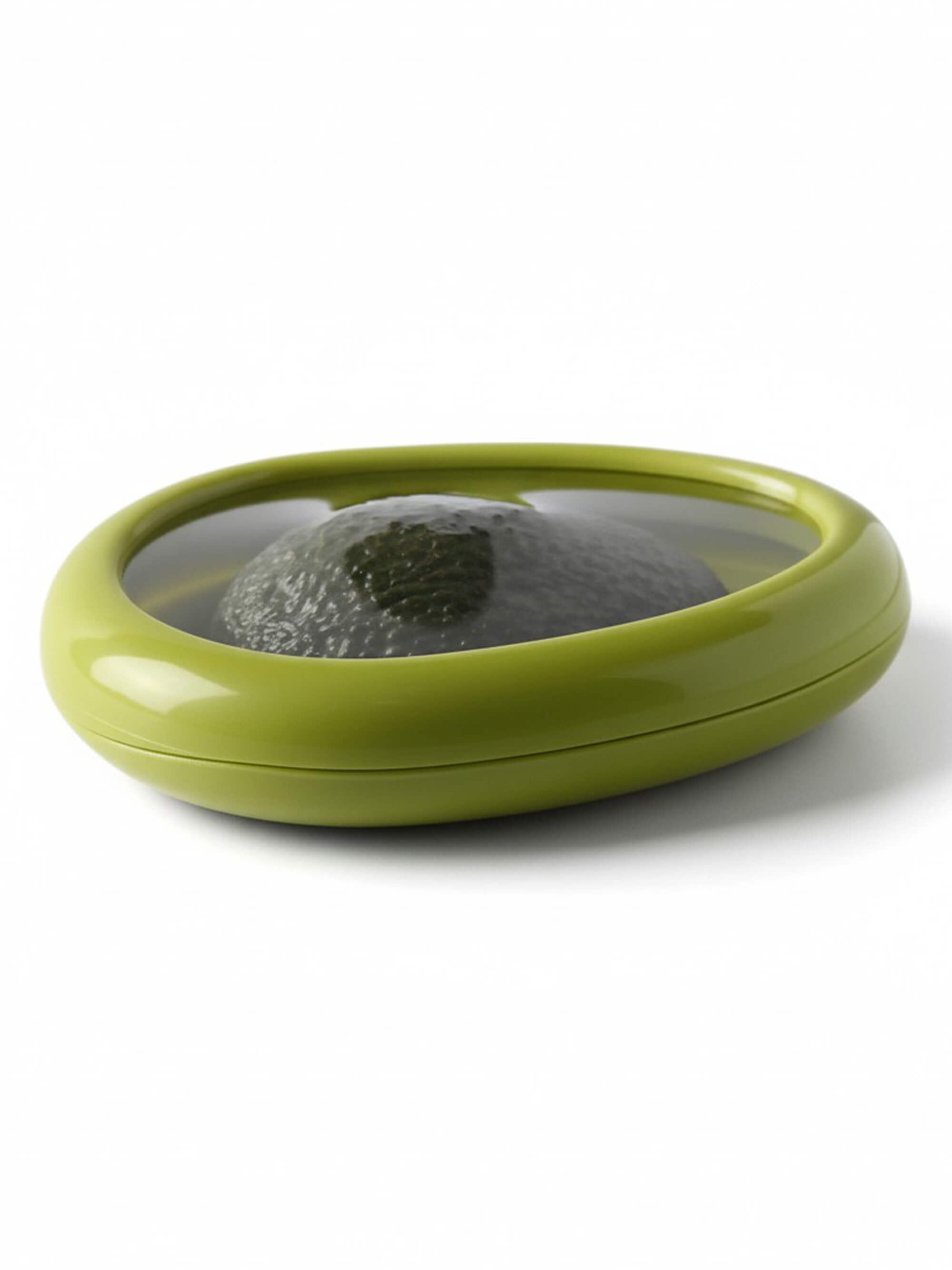 Reusable silicone avocado saver container storing half avocado with flexible seal lid on white background