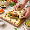 Honey bee beeswax wrap roll used to wrap sandwich with eco-friendly food storage alternative