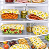 Reusable beeswax food wraps covering fruit and bowls in fridge storage