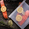 Reusable silicone freezer bag storing fresh salmon and vegetables